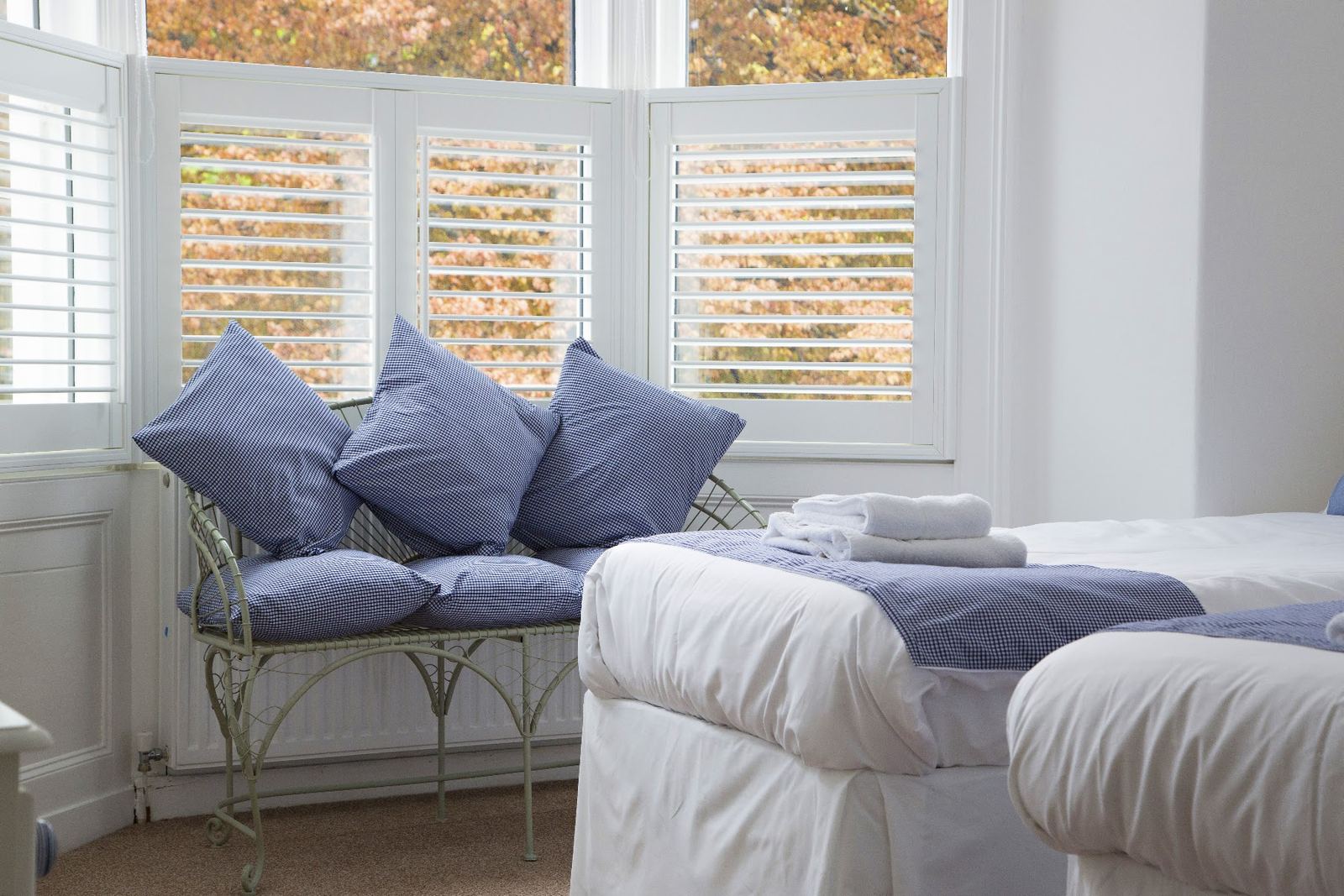 A bright bay-window bedroom at Linnett Hill, Keswick